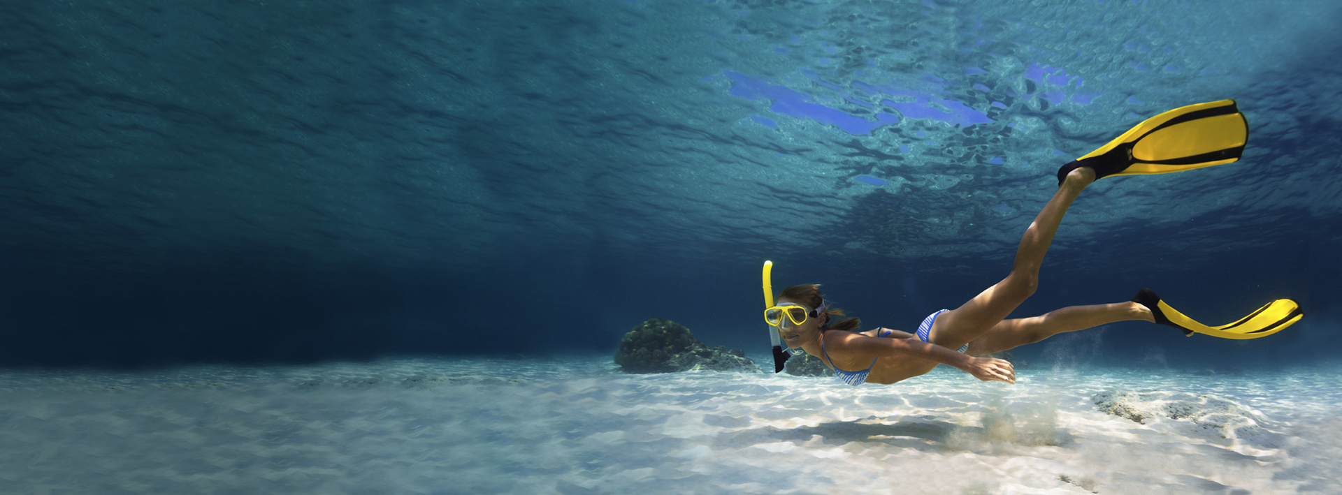 Swimmer with fins underwater